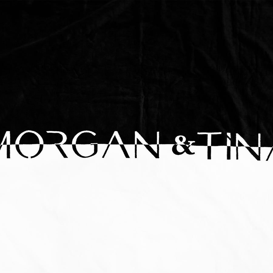 The close-up shot of Morgan & Tina's black and white luxury bath towel.